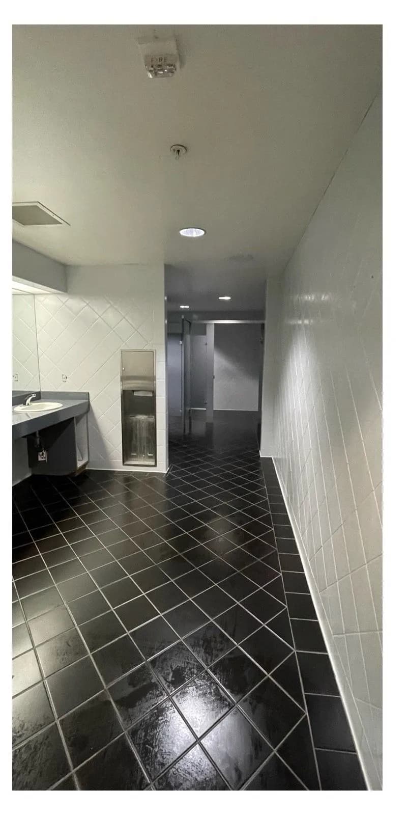 After: Commercial restroom diamond-pattern tile wall before and after refinishing